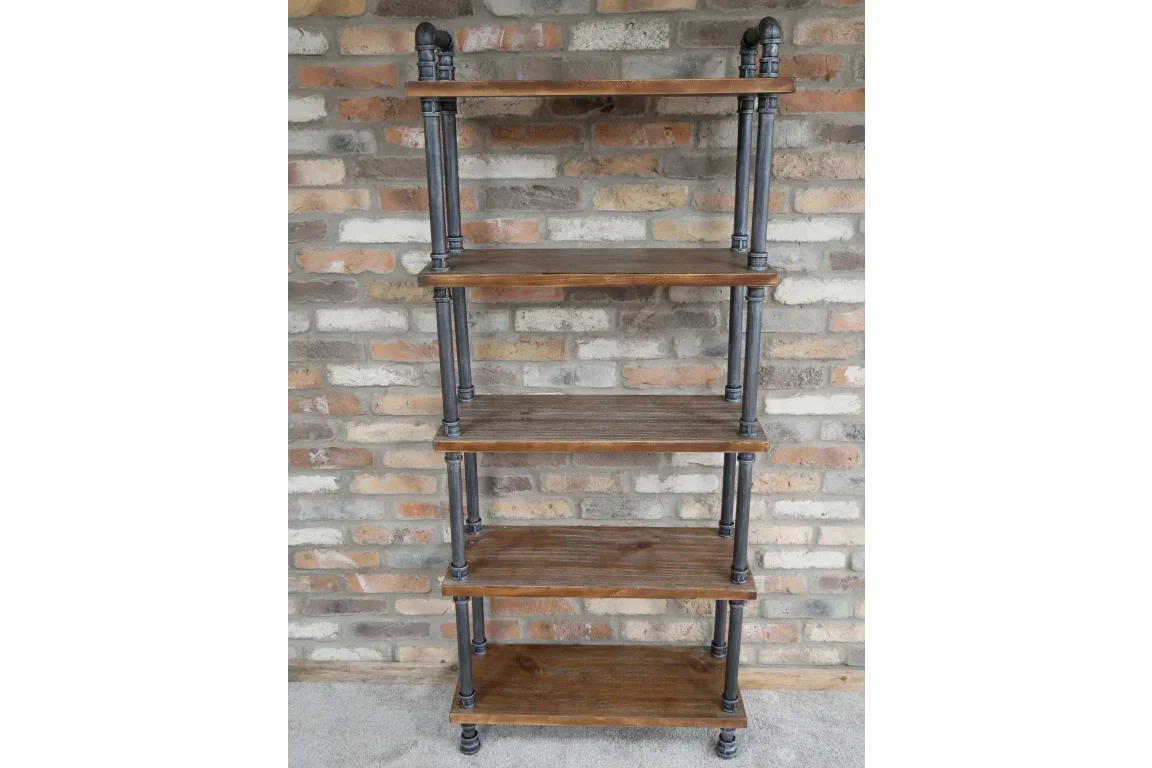 Industrial wood and metal shelving unit with five shelves against brick wall