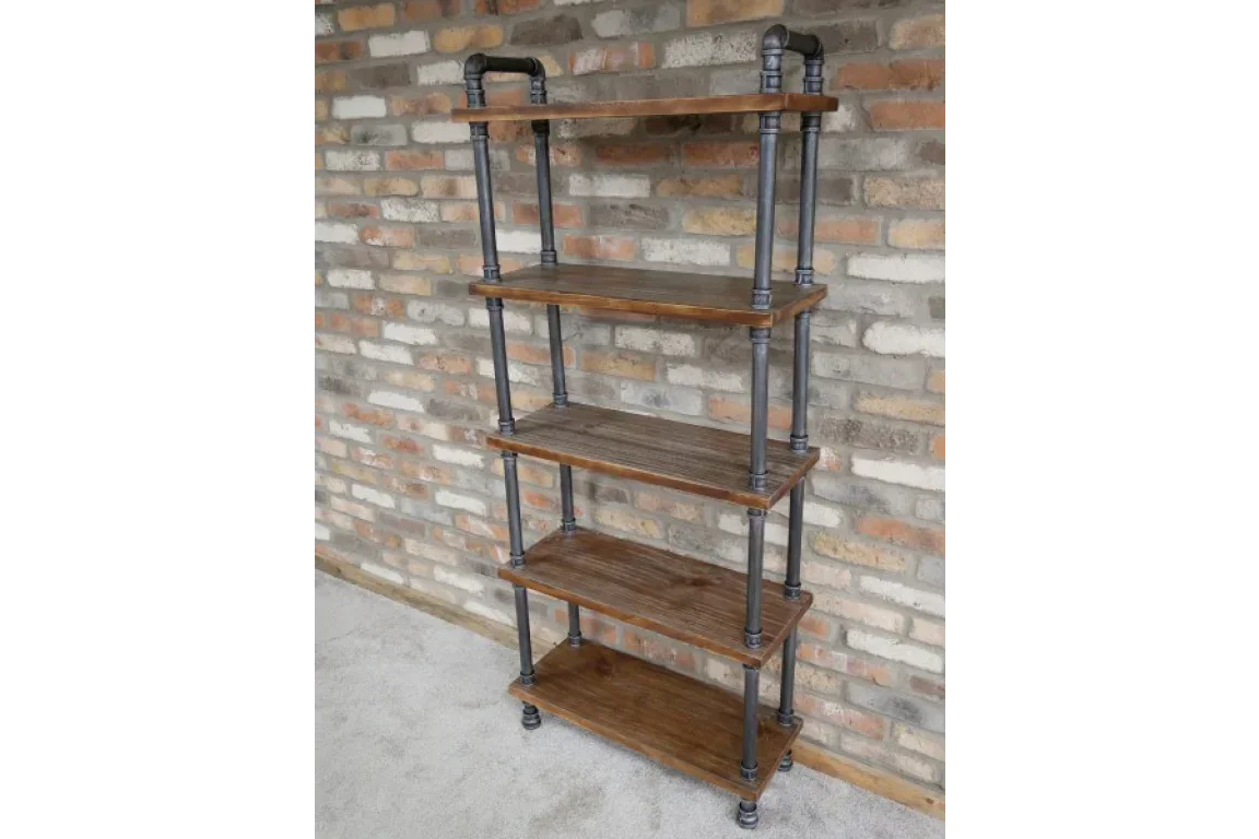 Industrial shelving unit with metal pipes and wooden shelves against brick wall