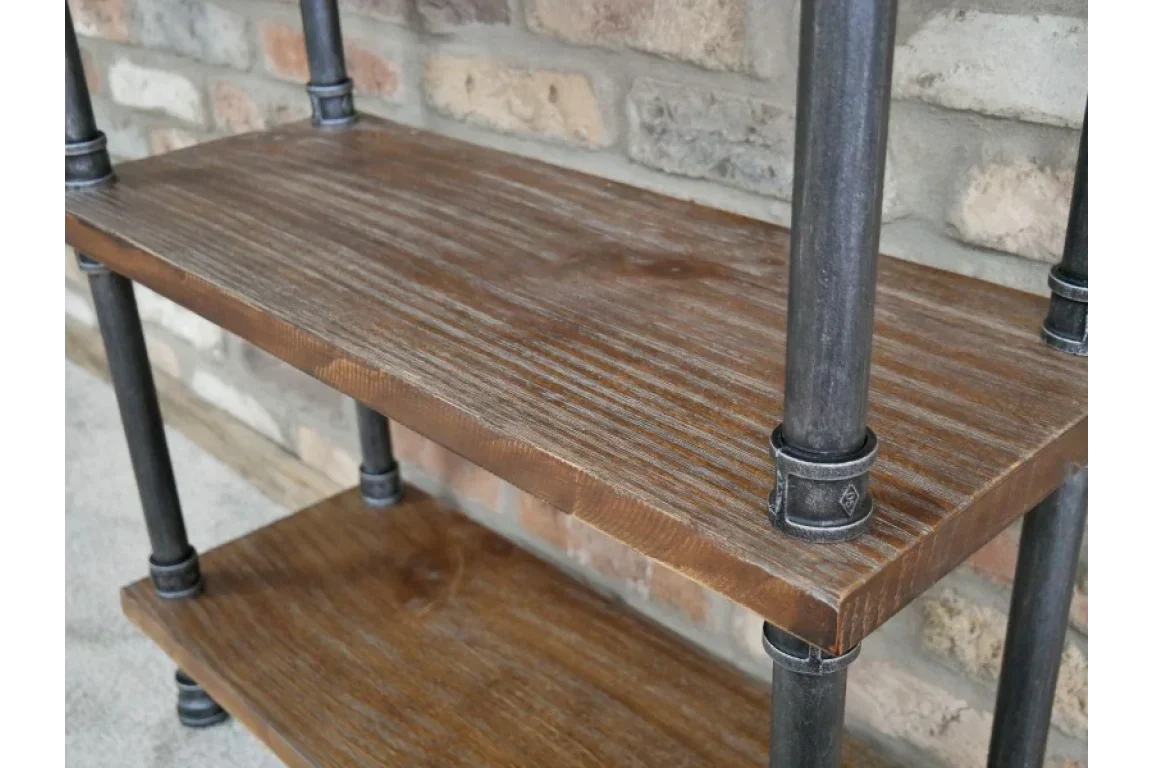 Industrial wood shelving unit with black metal pipe frame against brick wall