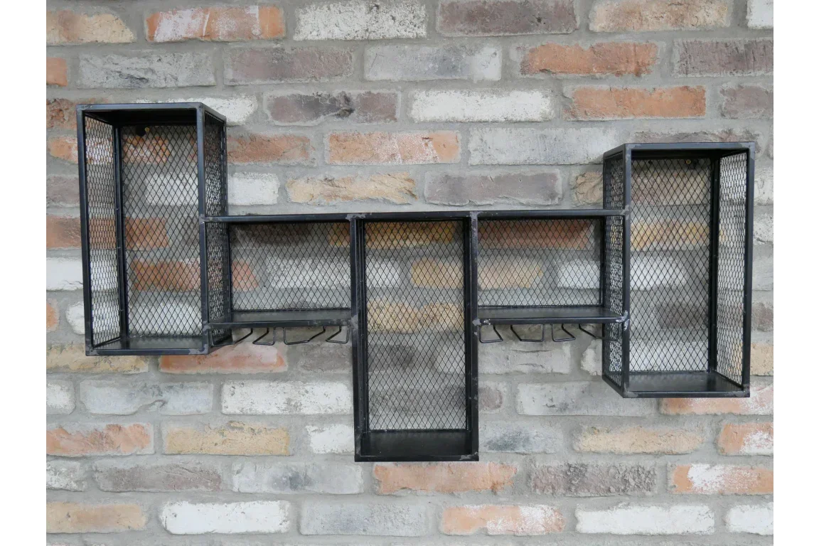 Black metal wall shelf with mesh panels and hooks mounted on exposed brick wall