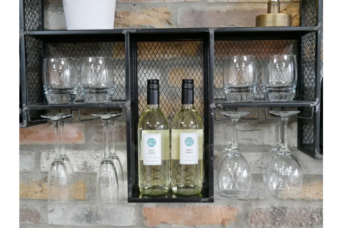 Wall mounted wine rack with two white wine bottles, six glasses against brick backdrop