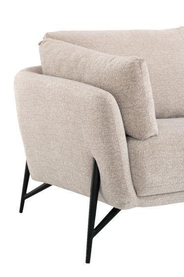 Beige fabric sofa arm detail with black metal legs and plush cushions