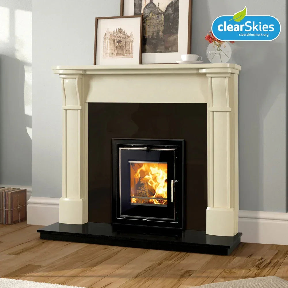 Modern wood burning stove with cream fireplace surround and black hearth on wooden floor