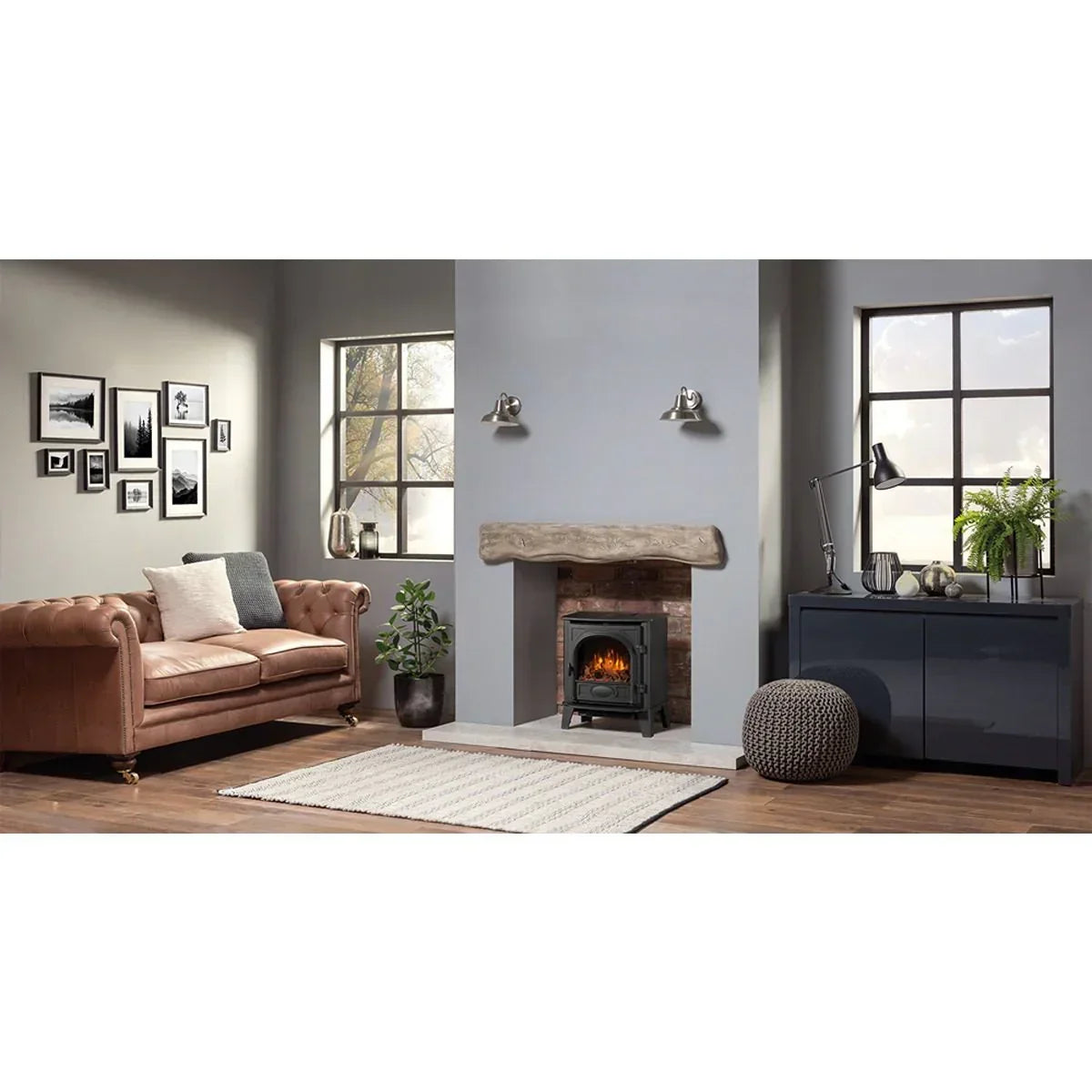 Brown leather sofa and electric fireplace in modern living room with wooden floor and decor