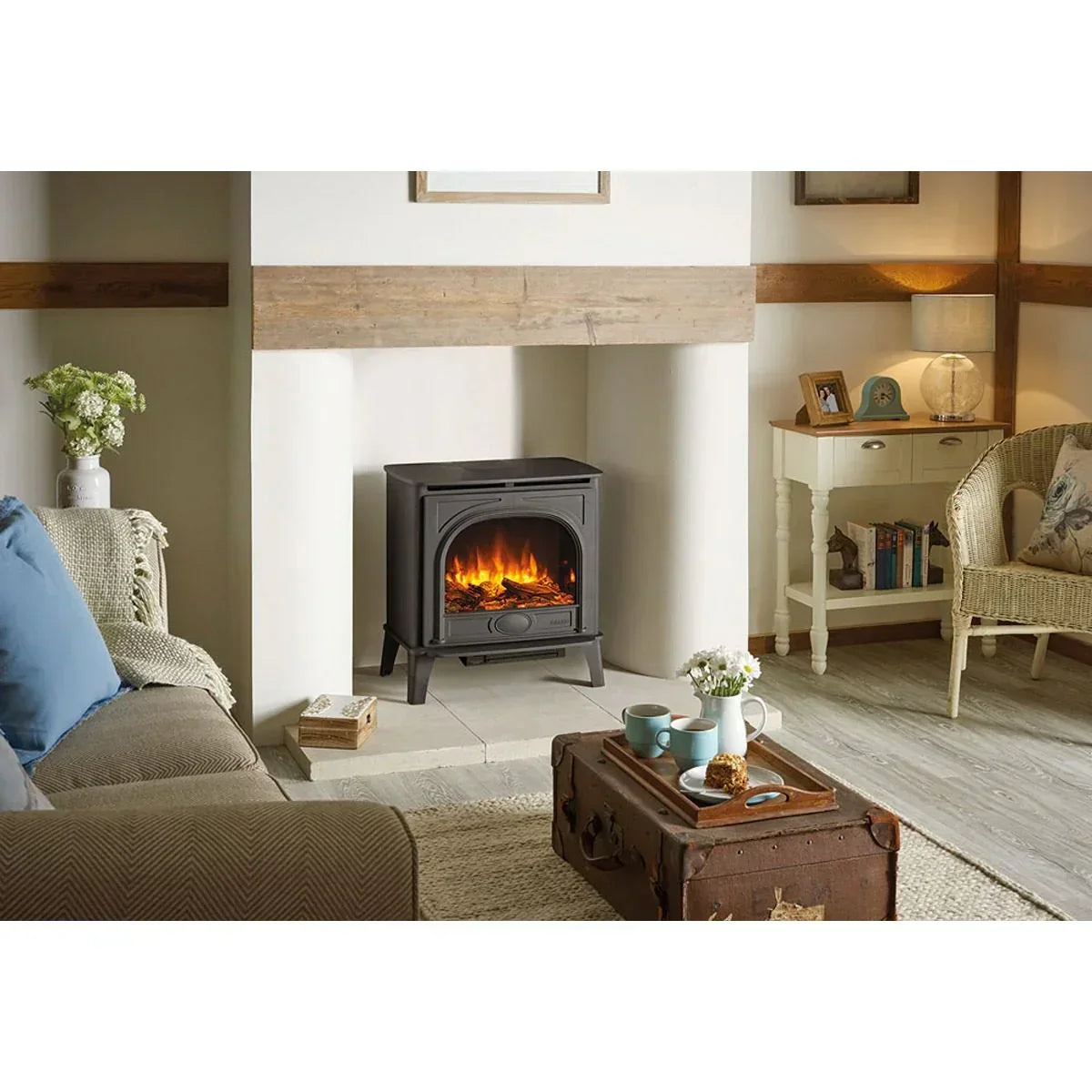 Black electric stove heater with flame effect in cosy living room setting