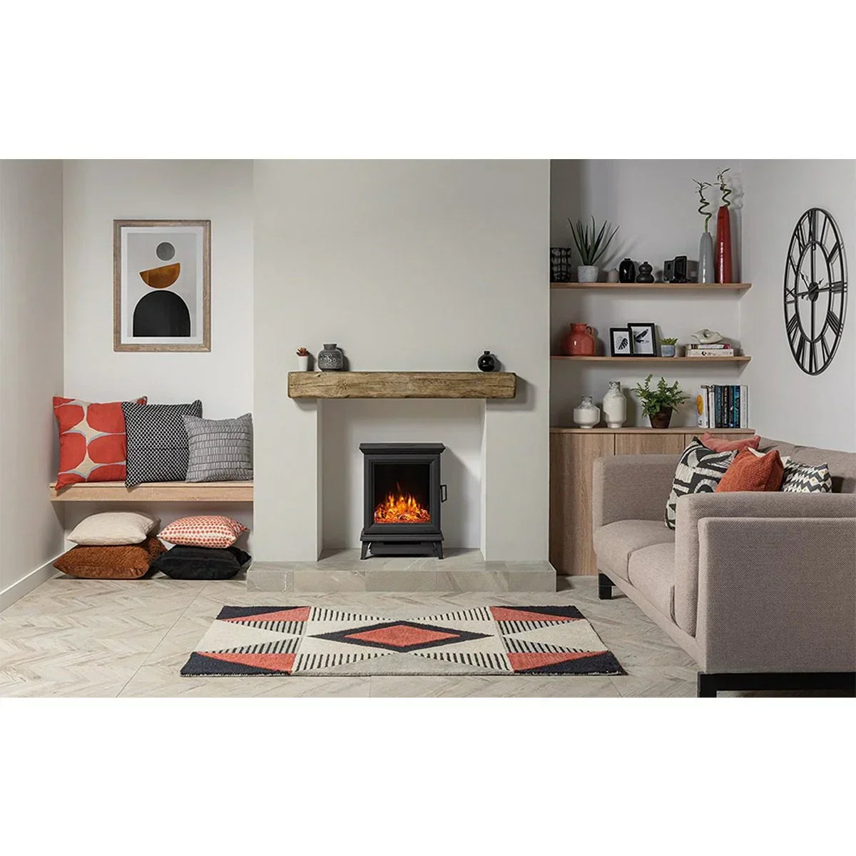Modern living room with beige sofa, patterned rug, electric stove fire and accent cushions