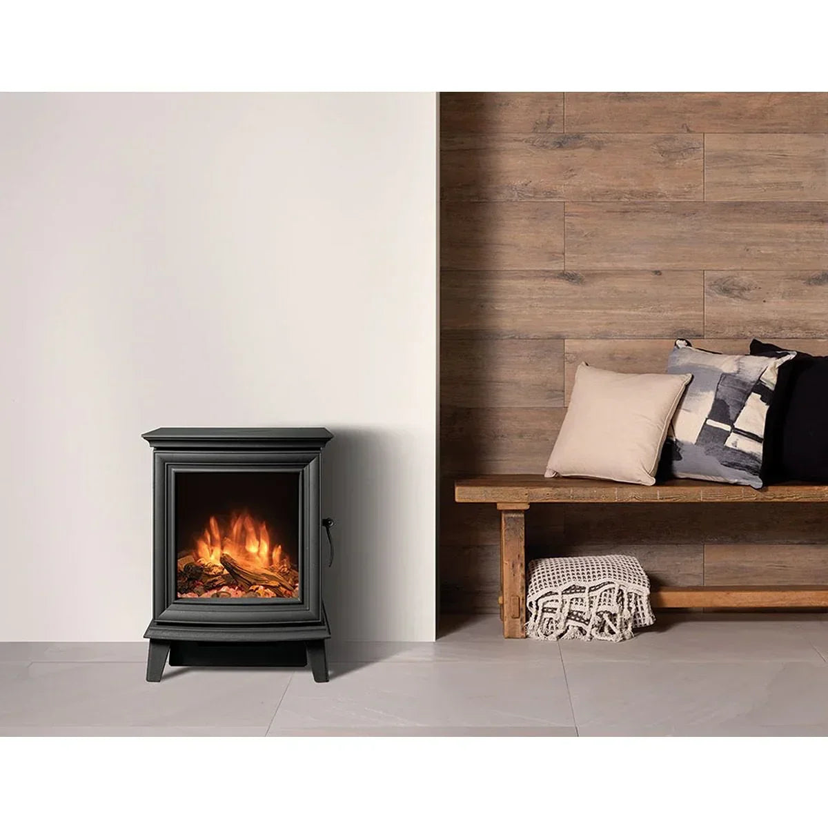 Black electric fireplace heater beside rustic bench with cushions in modern living room