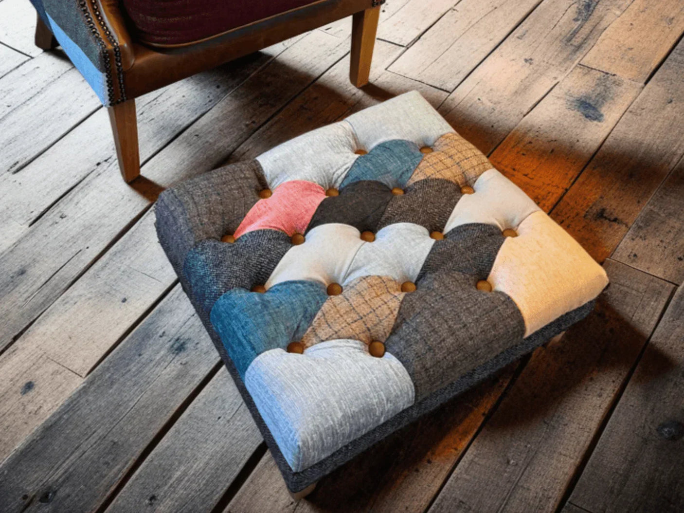 Patchwork floor cushion with button tufting on rustic wood flooring