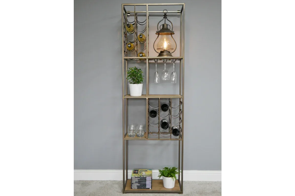 Tall metal and wood wine rack with shelves, wine bottles, hanging glasses, lamp, and potted plants