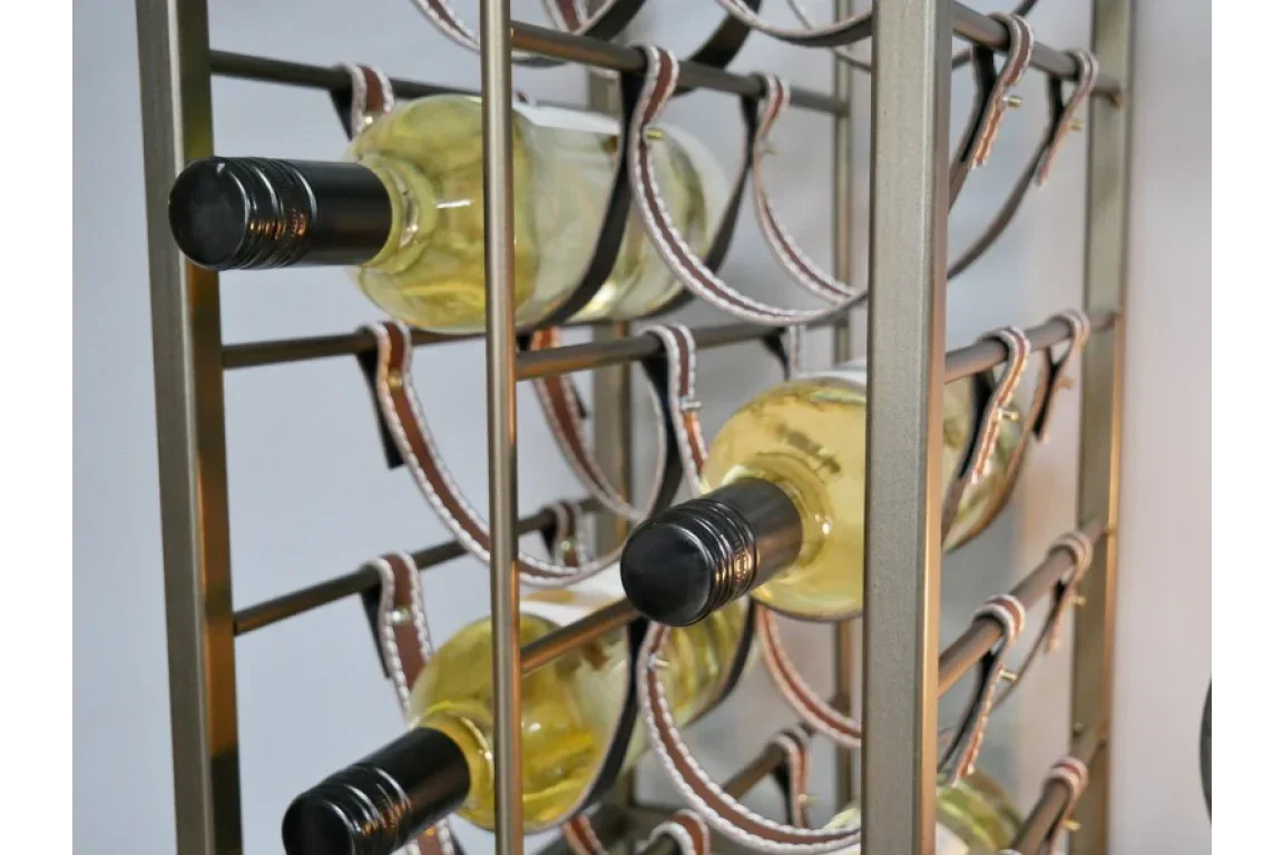 Metal wine rack holding several bottles of white wine on a modern display