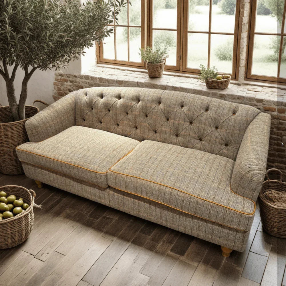 Beige fabric sofa with button-tufted backrest and yellow piping in a bright living room