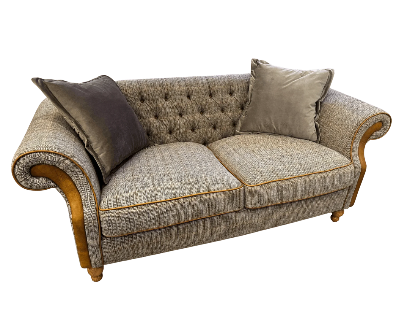 Grey fabric sofa with button-tufted back, mustard piping, rolled arms and two plush cushions