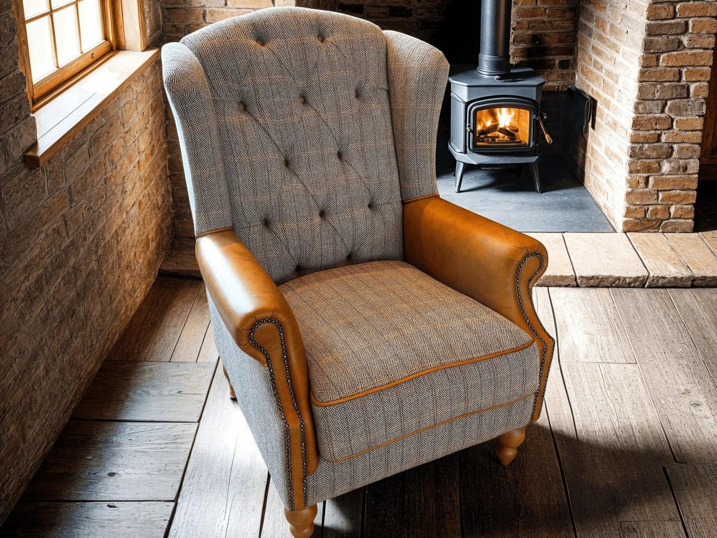 Button tufted armchair with herringbone fabric and tan leather arms in rustic lounge setting