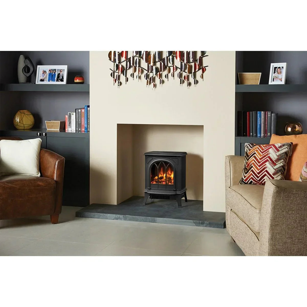 Black electric fire stove in modern living room with brown and beige sofas and styled shelves