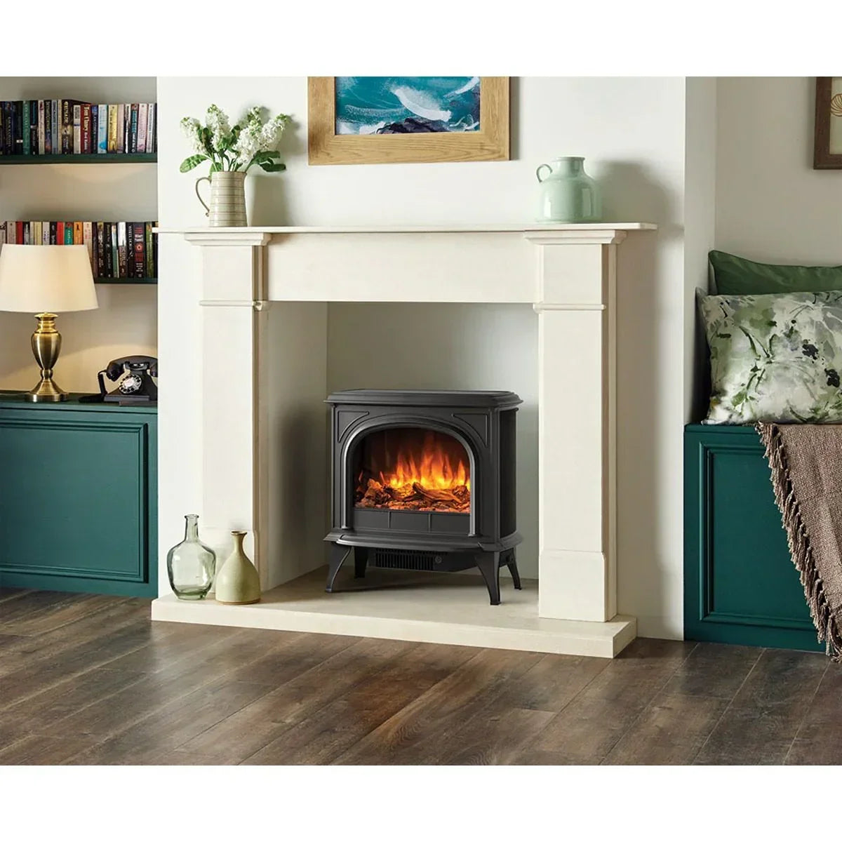 Black electric stove heater with realistic flame effect inside cream fireplace surround