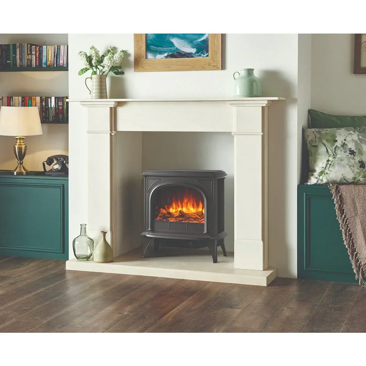 Cast iron electric stove fire set in cream fireplace with realistic glowing flame effect