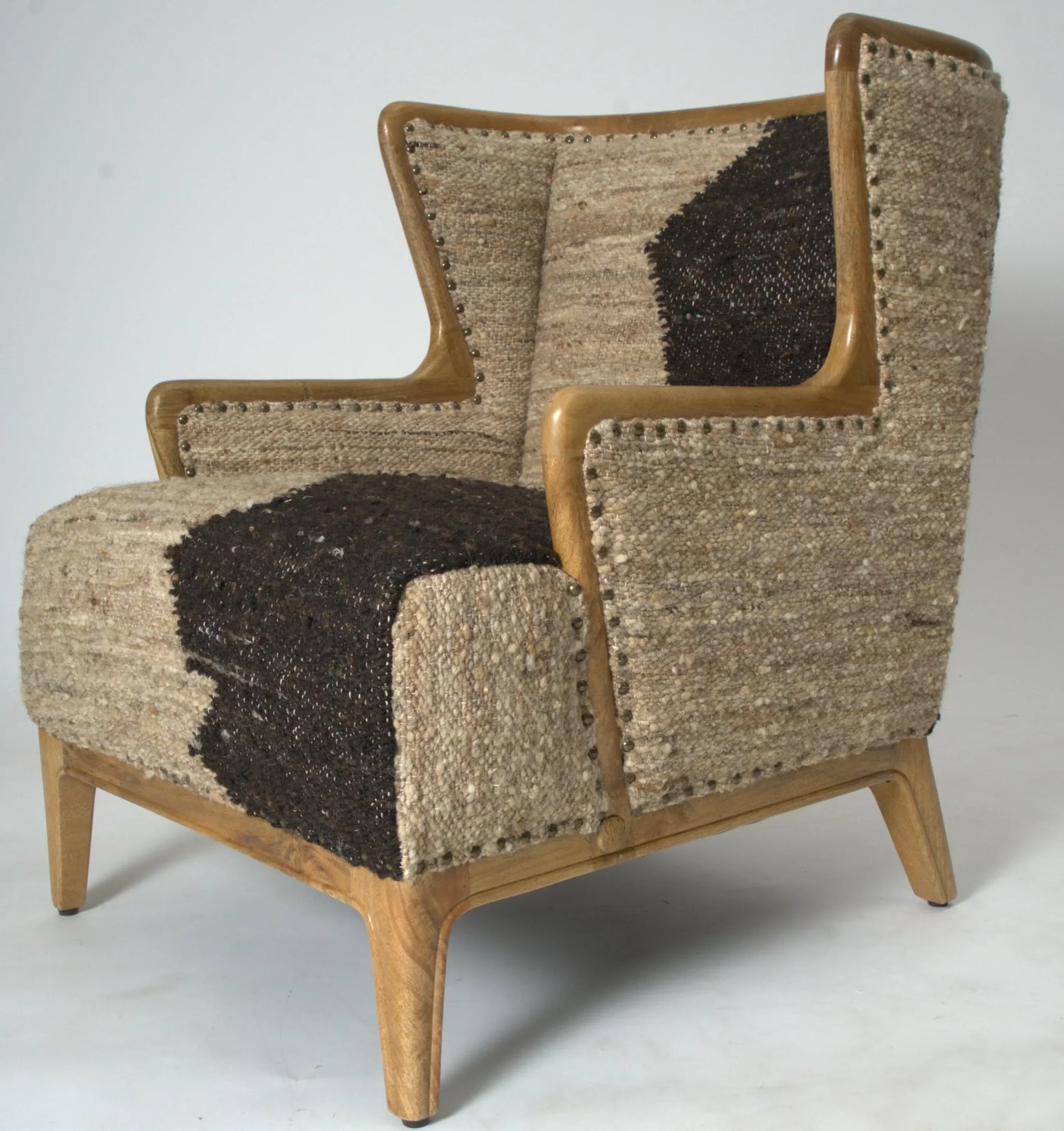 Brown textured armchair with wooden frame and geometric fabric accent