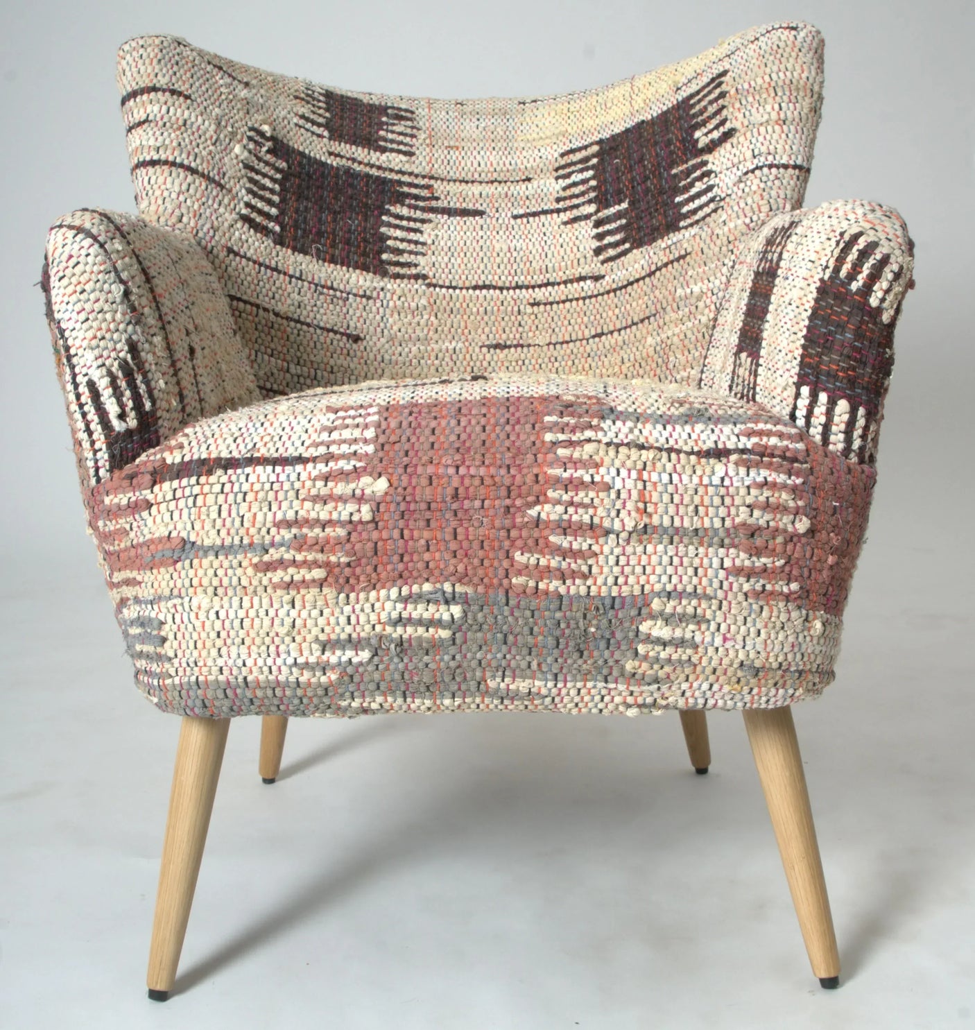 Patterned fabric armchair with wooden legs and wide seat, front angle view