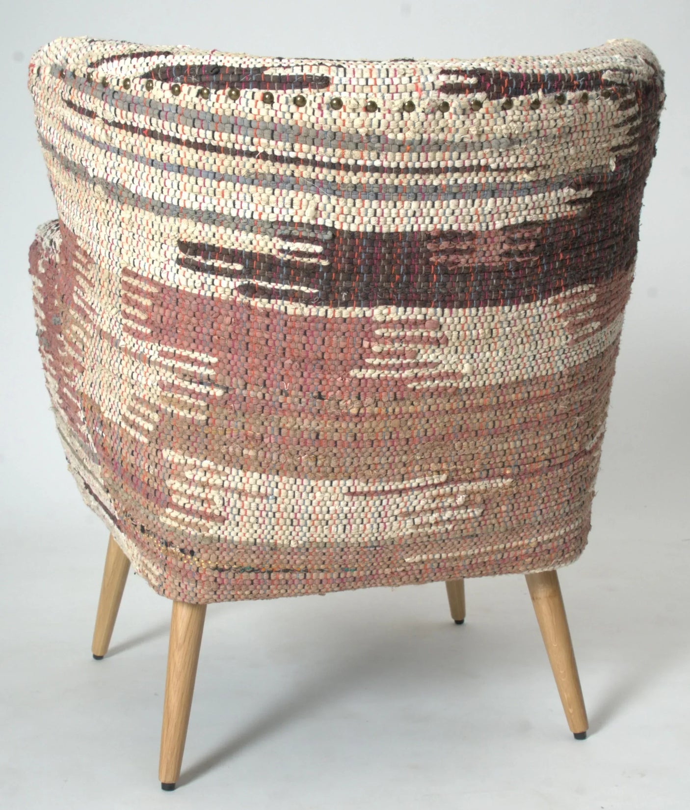 Patterned woven accent chair with wooden legs in beige and earthy tones, rear angle view