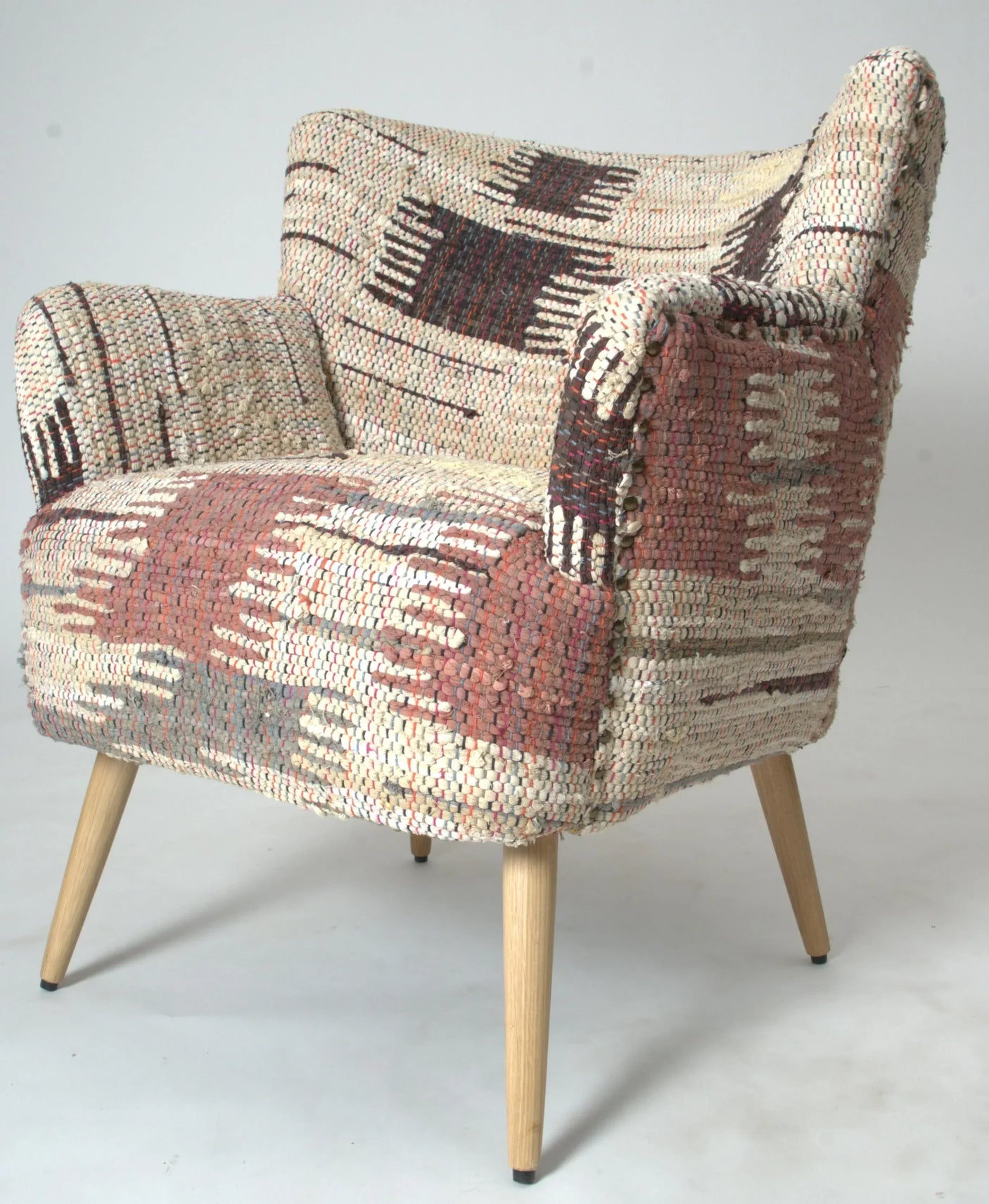 Patterned fabric accent chair with wooden legs in neutral and earthy tones