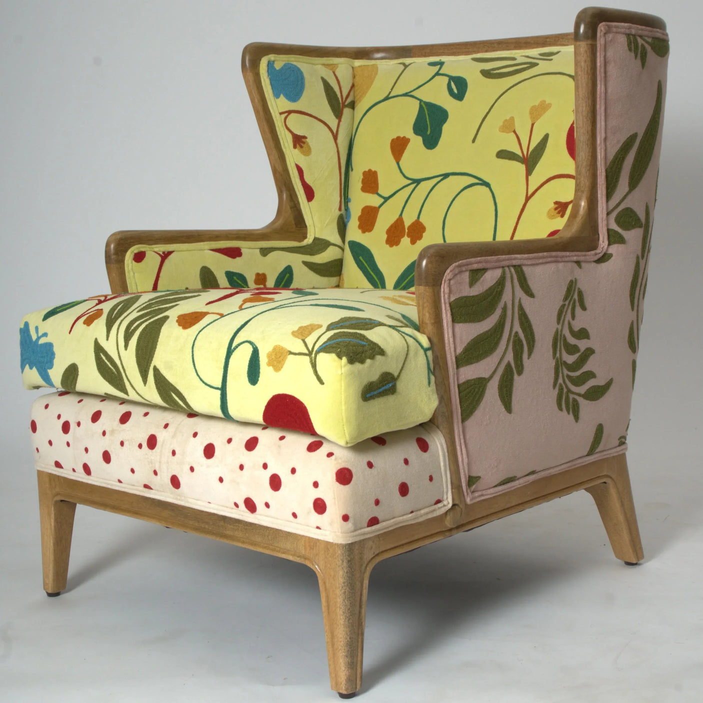 Patterned accent armchair with wooden frame, floral upholstery and red dot seat cushion