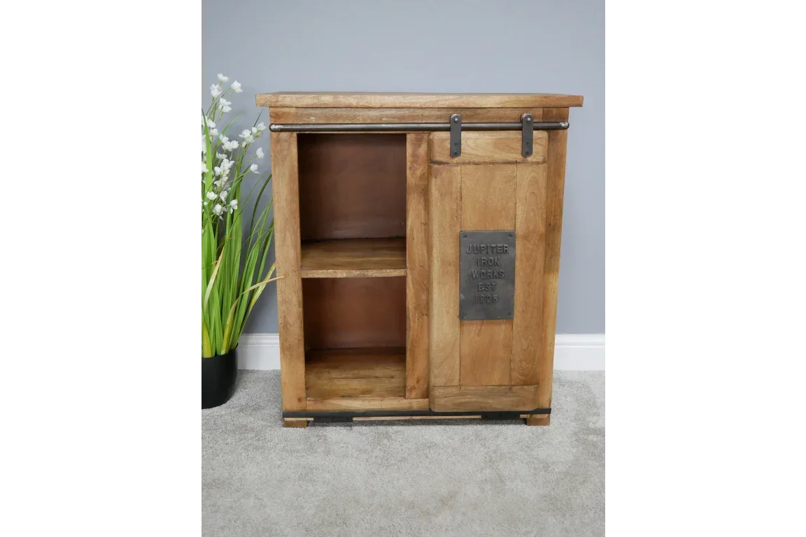 Rustic wooden sideboard with sliding barn door and two shelves, metal accent plate on front