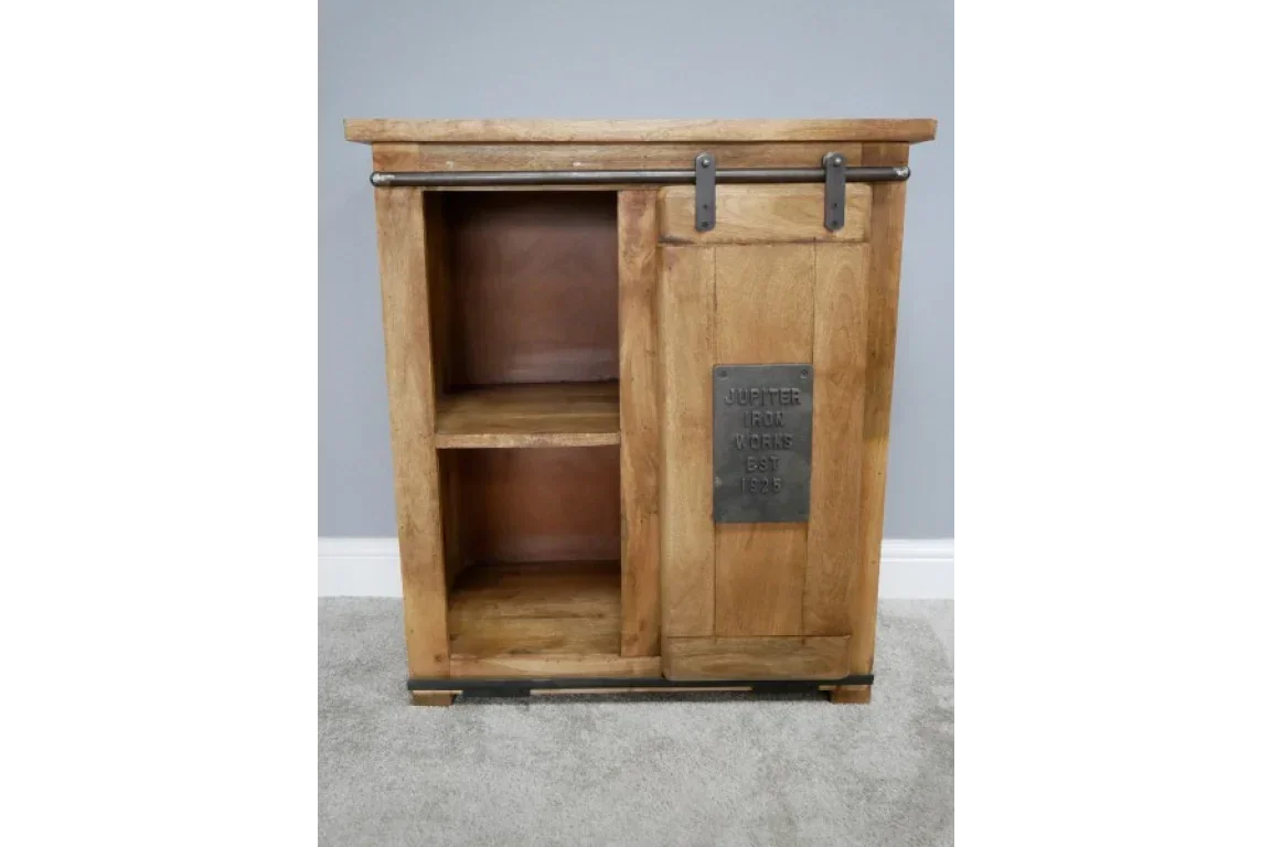 Rustic wood cabinet with sliding barn door and metal plaque, two open shelves visible