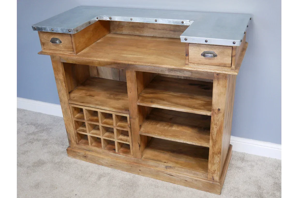 Rustic wooden bar cabinet with metal top, wine rack and open shelving on carpeted floor
