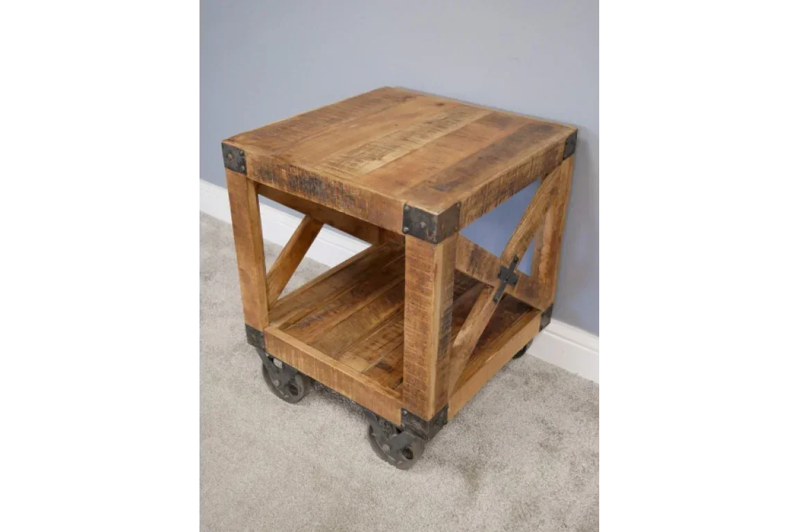 Rustic wooden side table with metal accents and castor wheels on carpeted floor