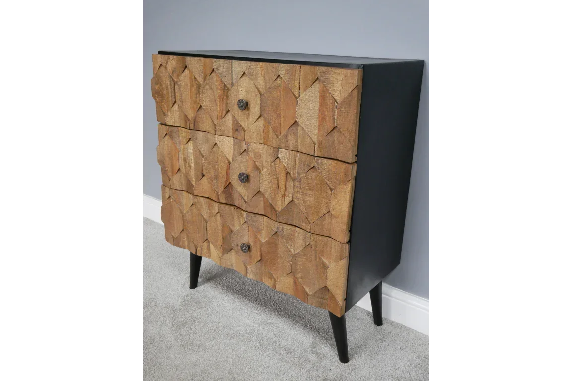 Three drawer wooden chest with geometric carved fronts and black frame on angled legs