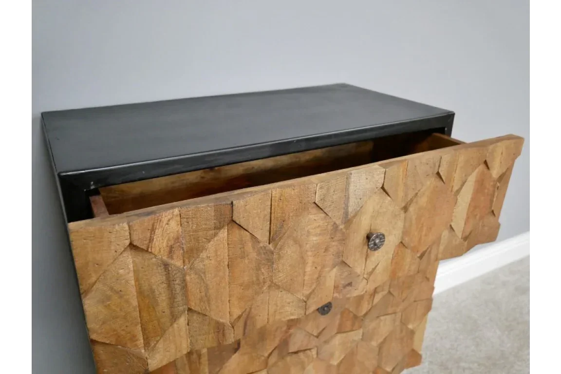 Geometric carved wood drawer unit with black top and open drawer, modern furniture design