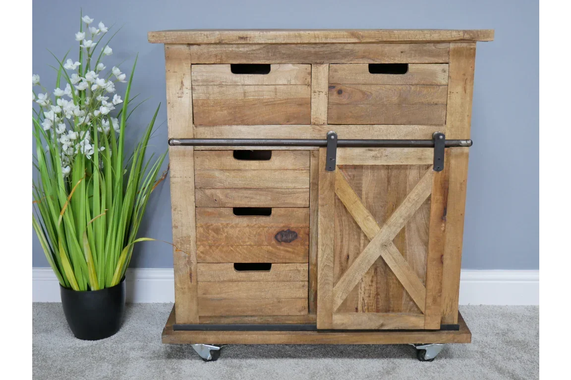 Rustic wooden sideboard with sliding barn door, drawers and metal accents on carpeted floor