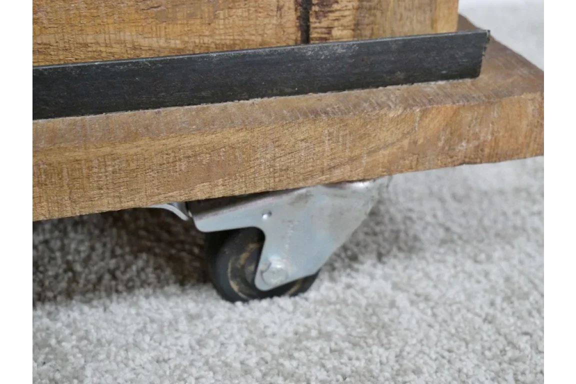 Close view of wooden furniture wheel caster on metal frame over carpet