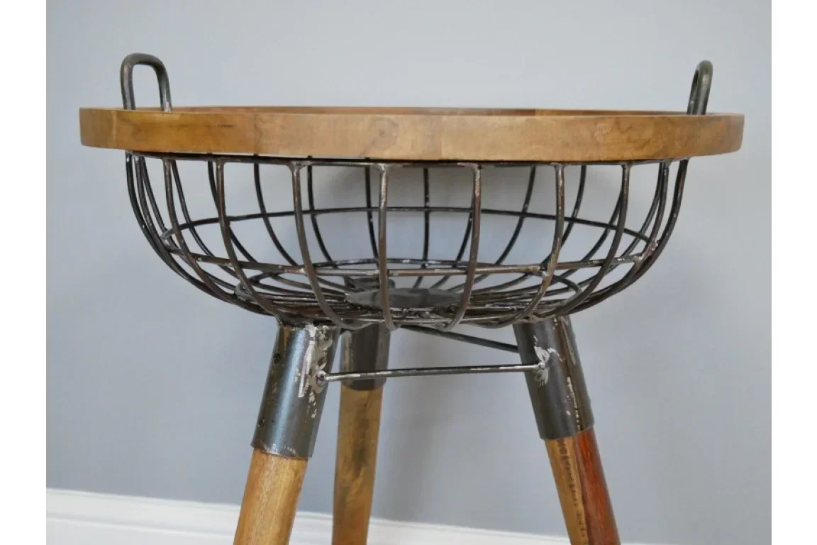 Industrial wire basket side table with wood top and tripod legs, close view