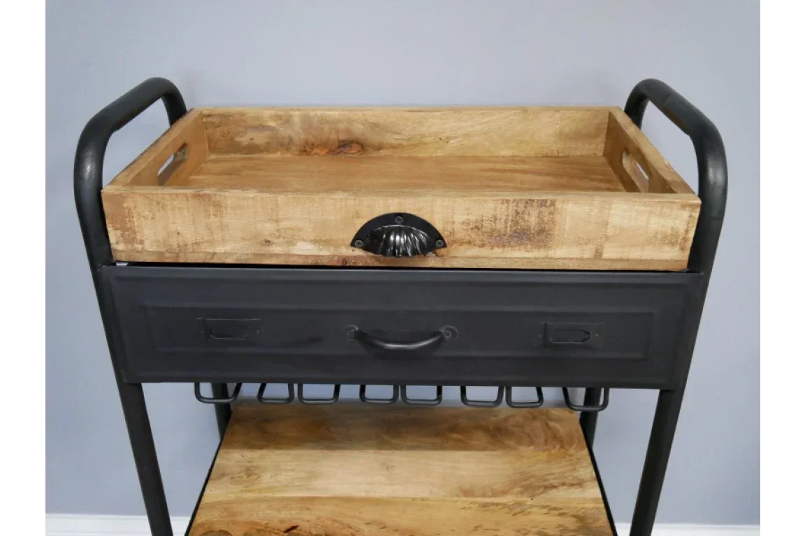 Industrial wooden and metal serving trolley with tray, drawer and shelf against grey wall