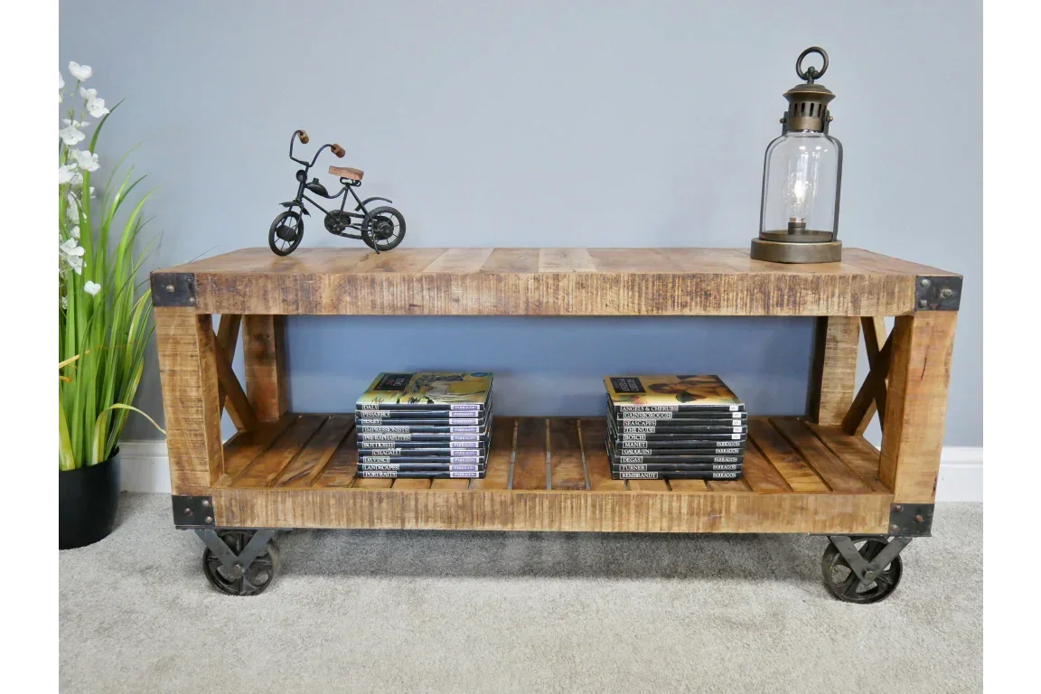 Industrial wood coffee table with open shelf, metal wheels, and decorative items displayed