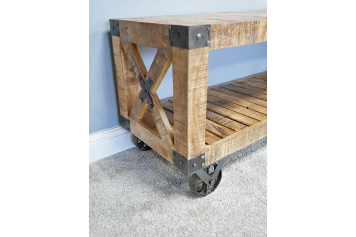 Industrial wooden console table with metal accents and wheels on carpeted floor