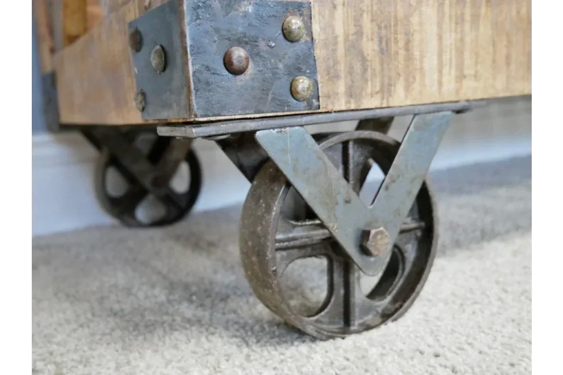 Close-up of industrial coffee table metal castor wheels on carpet