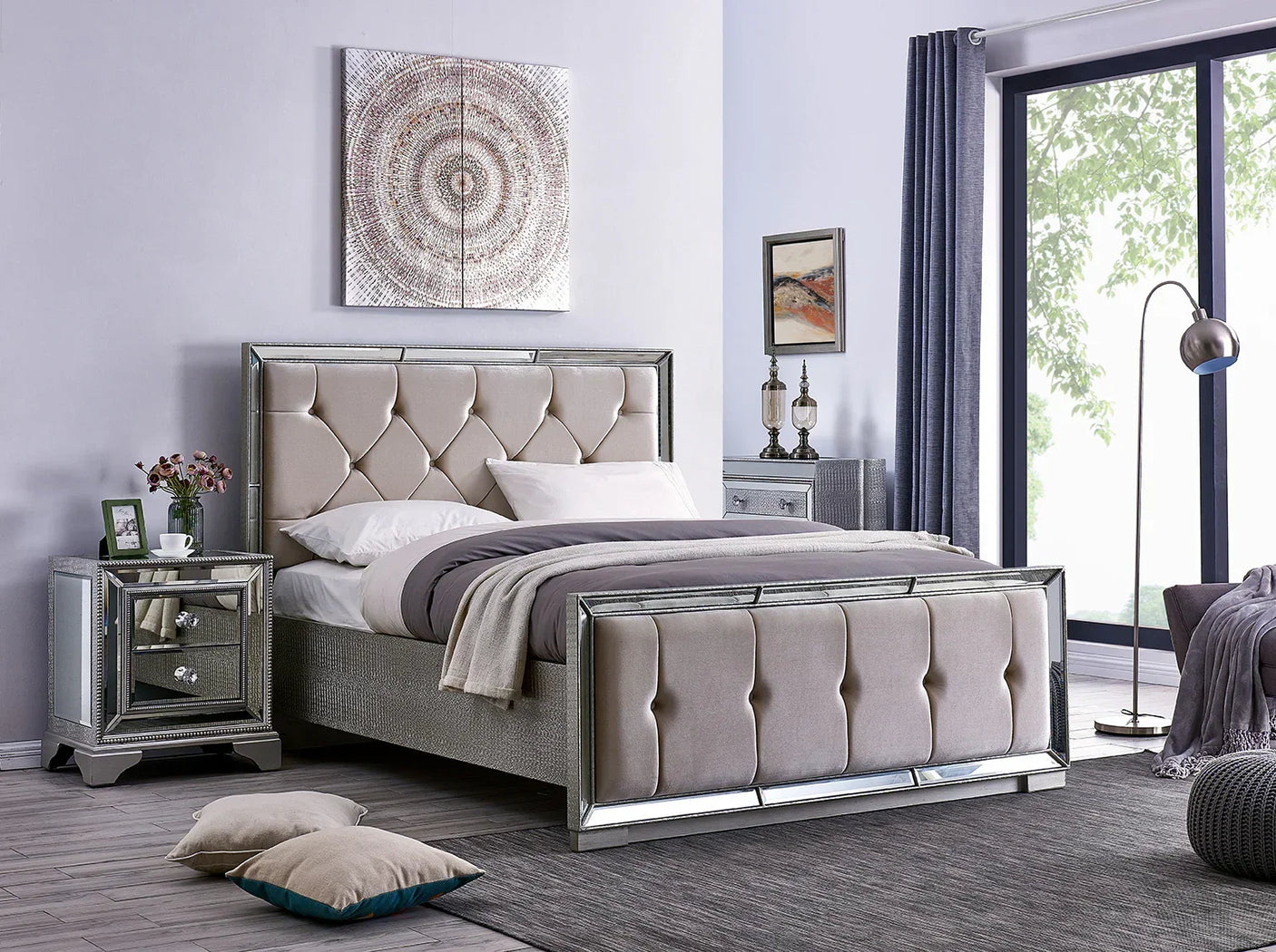 Tufted upholstered bed with mirrored frame, bedside tables, and grey bedroom decor