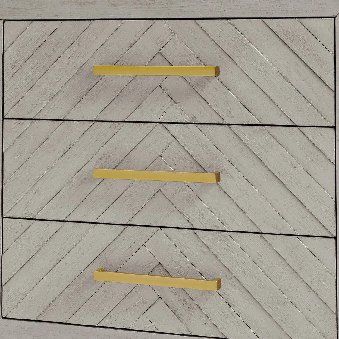 Chevron patterned wood chest of drawers with gold handles