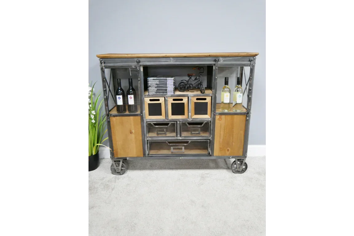 Industrial sideboard with metal frame, wood shelves, multiple drawers, bottles, and decor