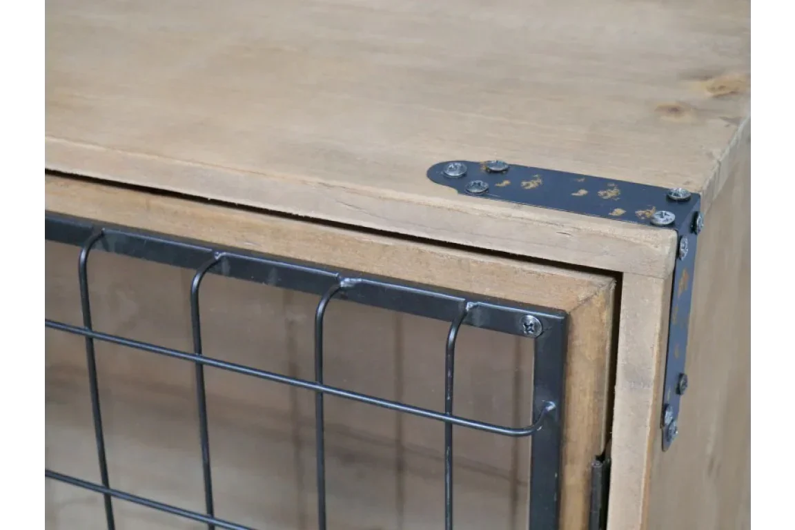 Closeup of wooden cabinet with black metal corner bracket and mesh door detail