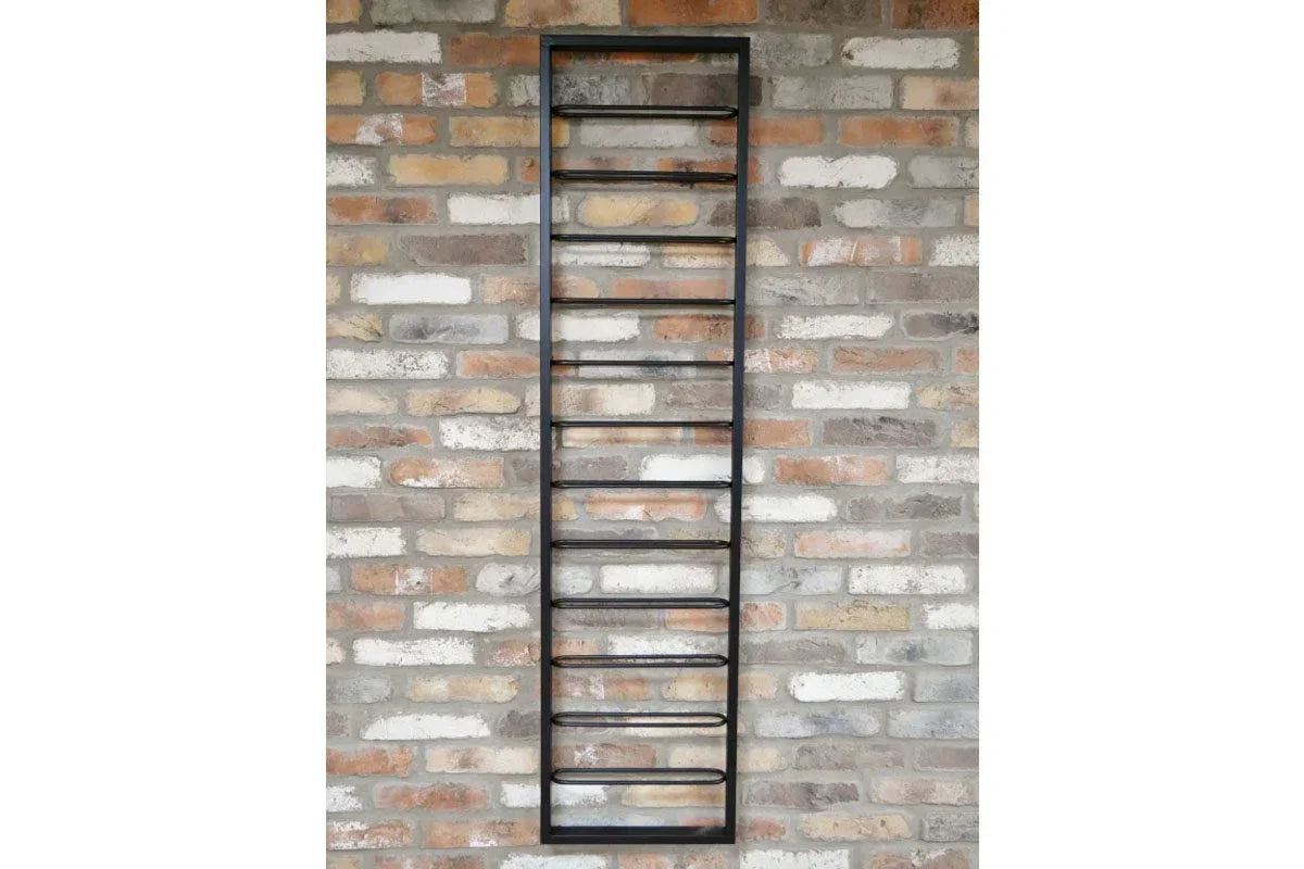 Black metal wine rack wall mounted on exposed brick wall