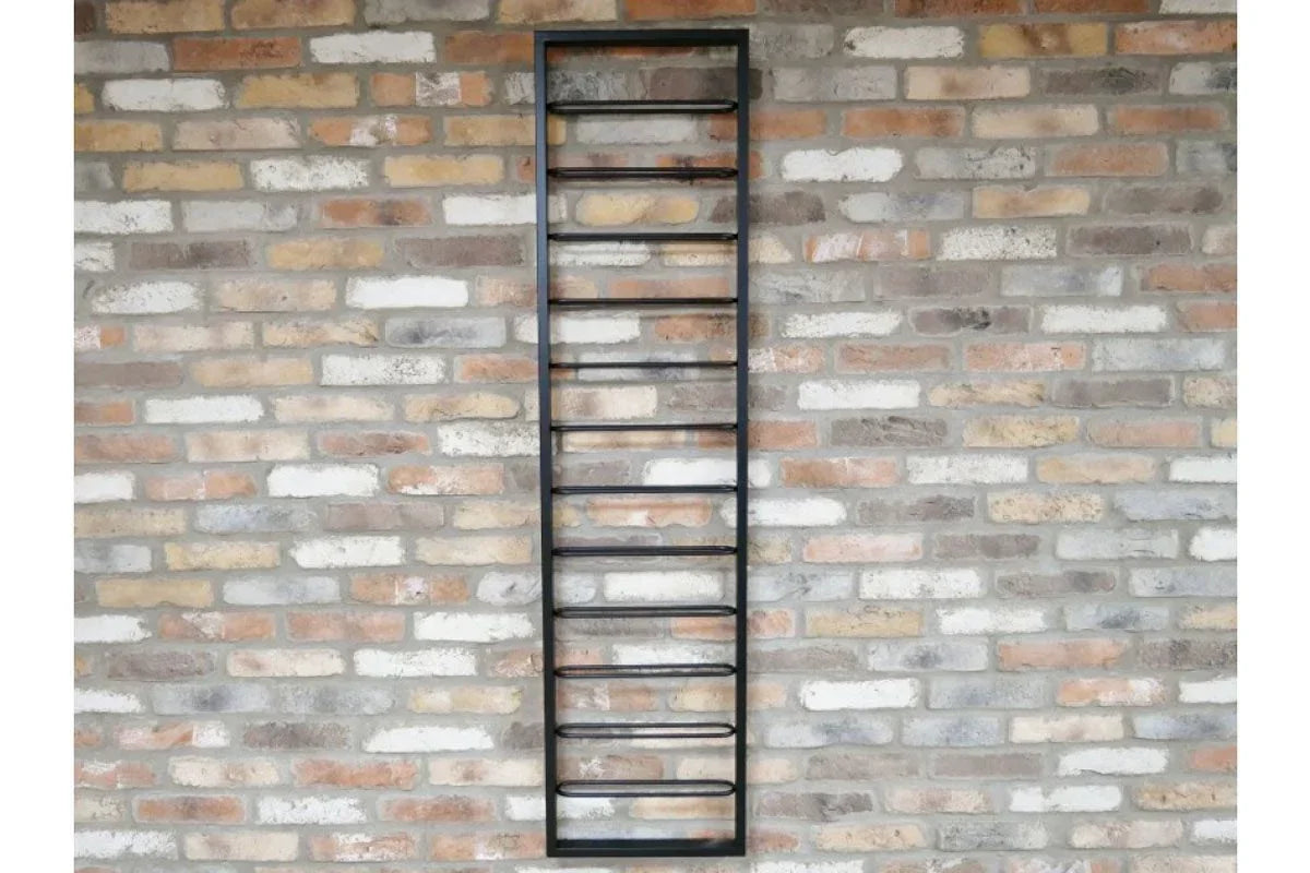 Black metal wall-mounted wine rack with ten holders against a brick wall