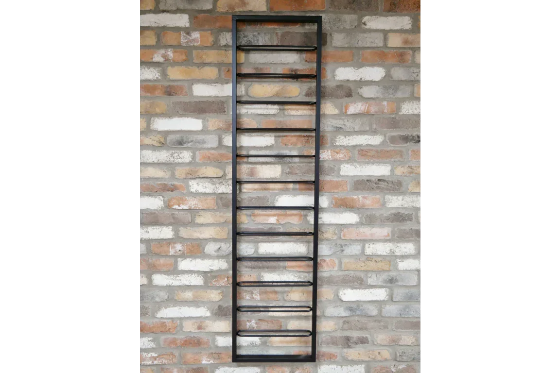 Black metal wall wine rack with horizontal bottle holders on brick wall