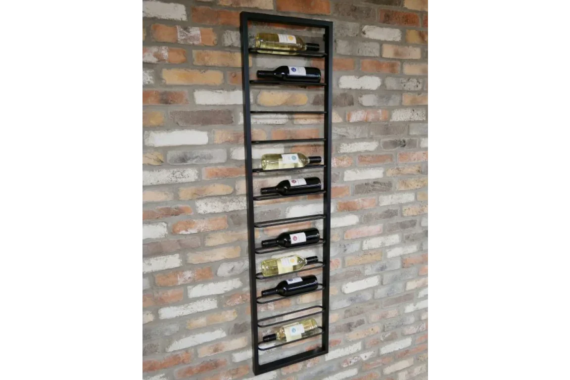 Wall-mounted metal wine rack holding bottles on exposed brick wall