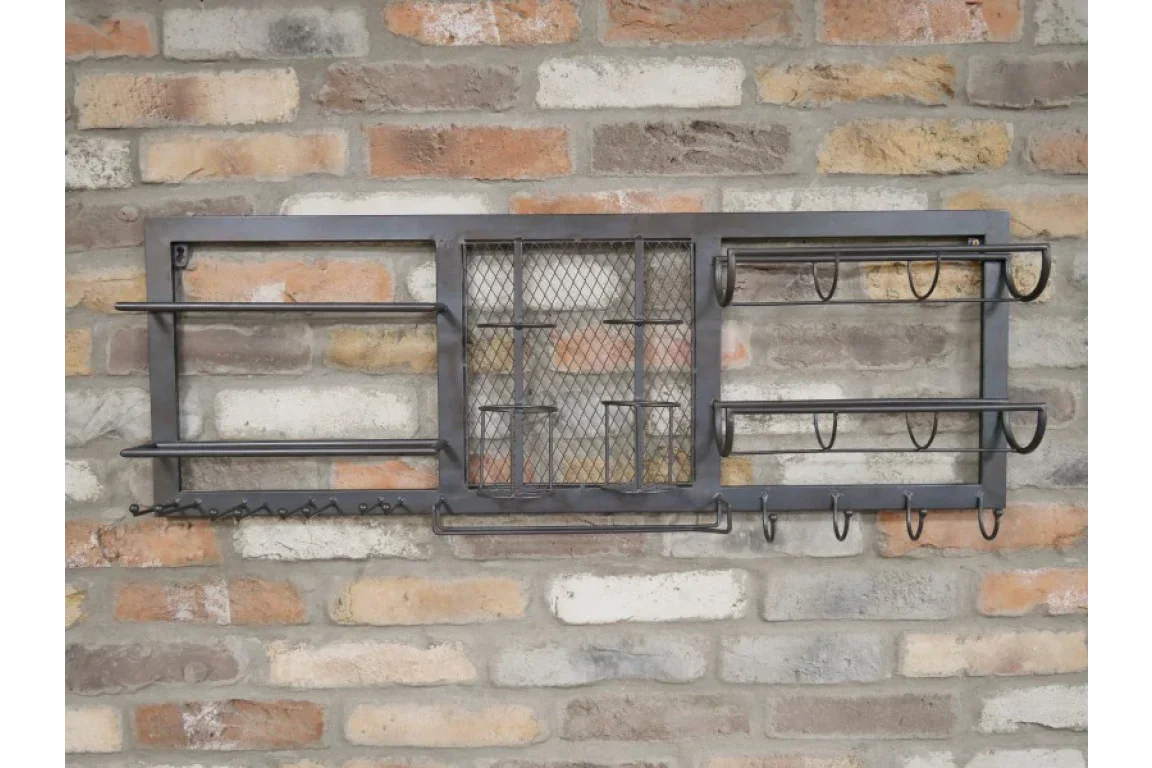 Black metal wall mounted kitchen rack with hooks and shelves on brick wall