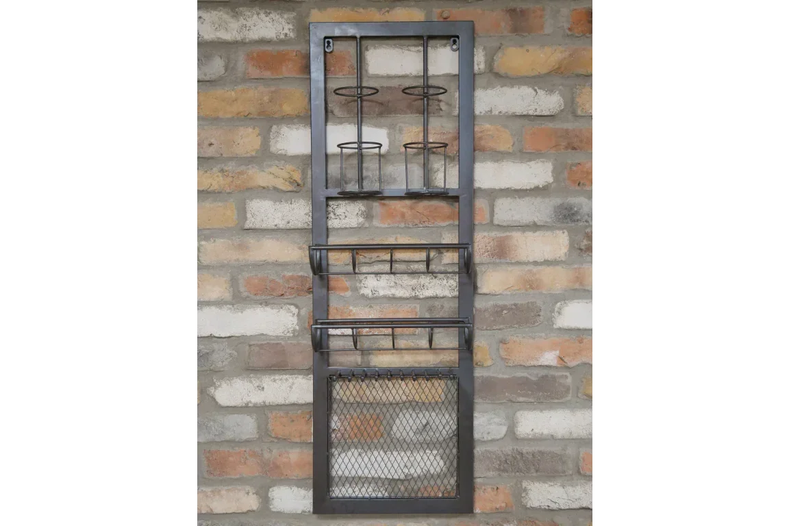 Black metal wall mounted storage rack with shelves and holders against brick wall