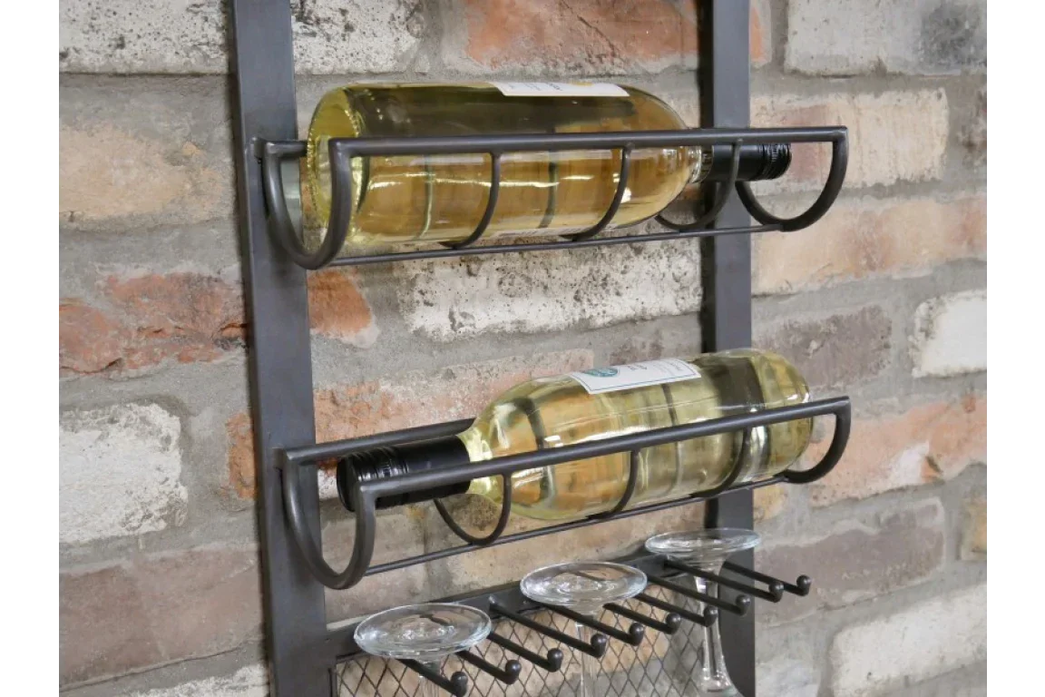 Wall mounted metal wine rack with two wine bottles and glass holders against brick wall