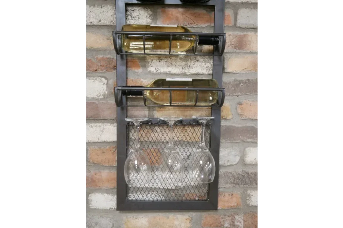 Wall mounted metal wine rack holding bottles and hanging wine glasses against brick wall